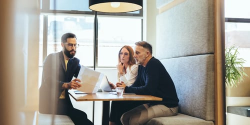 Tech startup founders discussing legal mistakes with a solicitor 